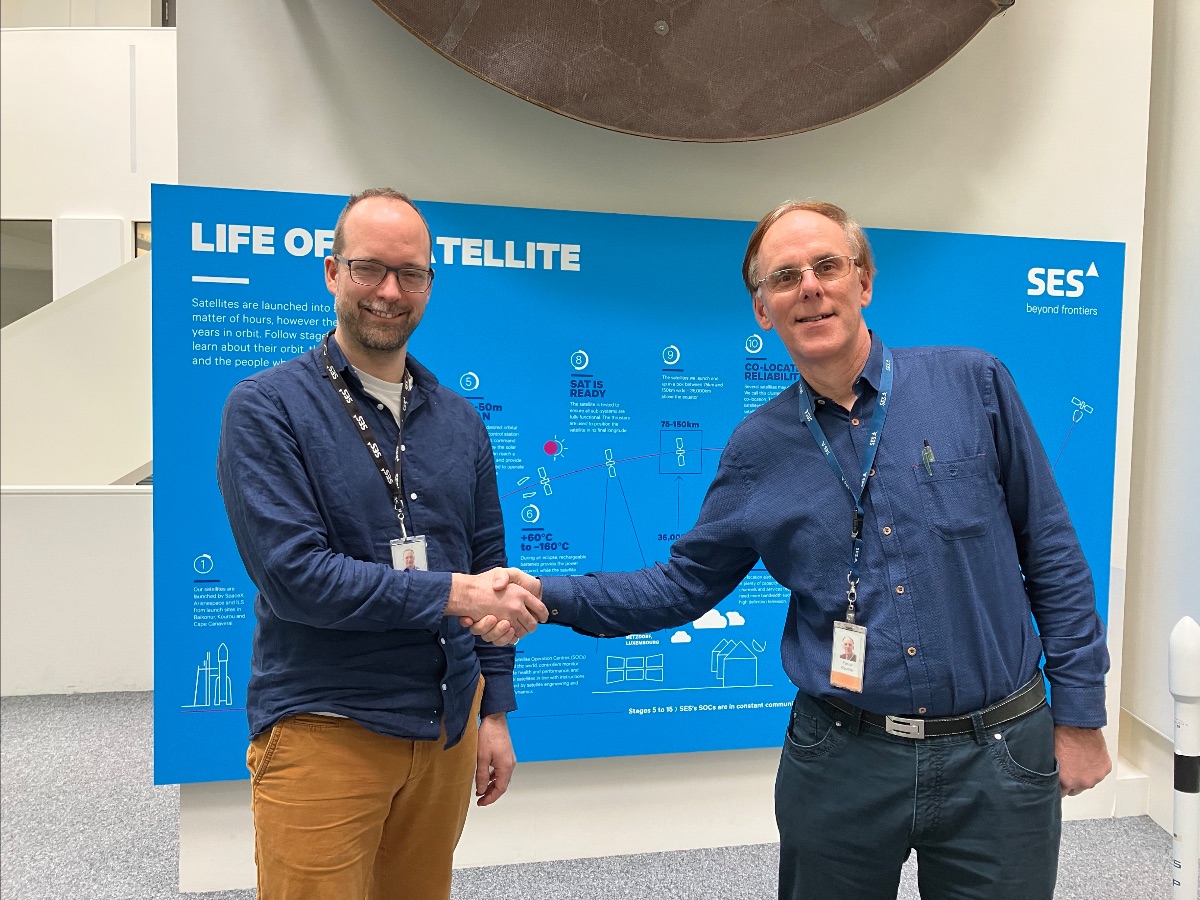 Charles Law (left) shaking hands with Pascal Wauthier (right).